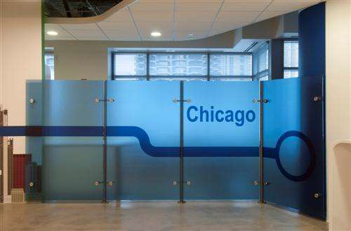 Glass partition continuing the CTA Blue Line theme in the office.